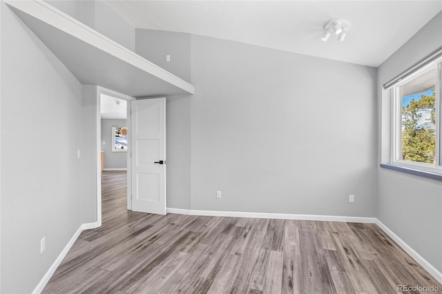 unfurnished room featuring baseboards and wood finished floors