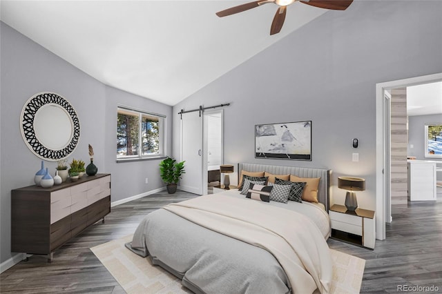 bedroom with ceiling fan, high vaulted ceiling, a barn door, wood finished floors, and baseboards