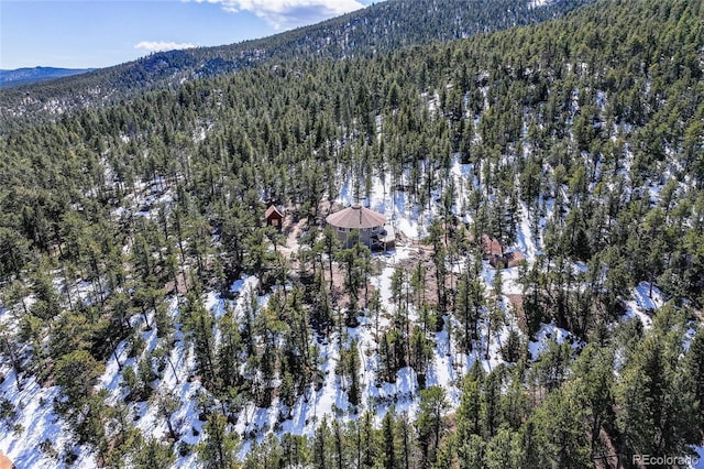 aerial view with a wooded view and a mountain view