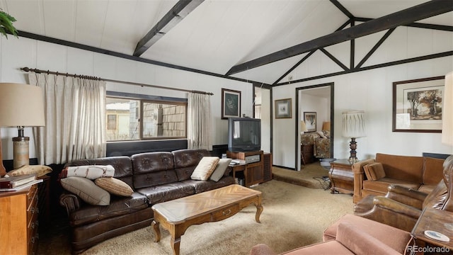 carpeted living room with lofted ceiling with beams