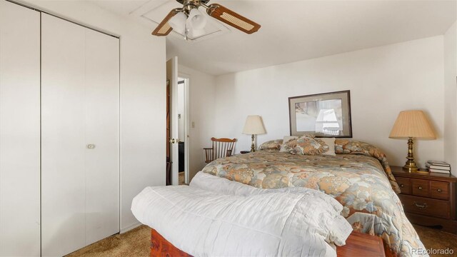 carpeted bedroom featuring ceiling fan and a closet