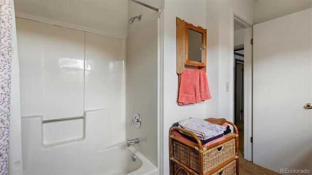 bathroom featuring shower / washtub combination and ornamental molding