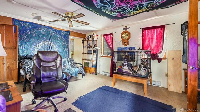 carpeted bedroom with baseboard heating, ornamental molding, and ceiling fan