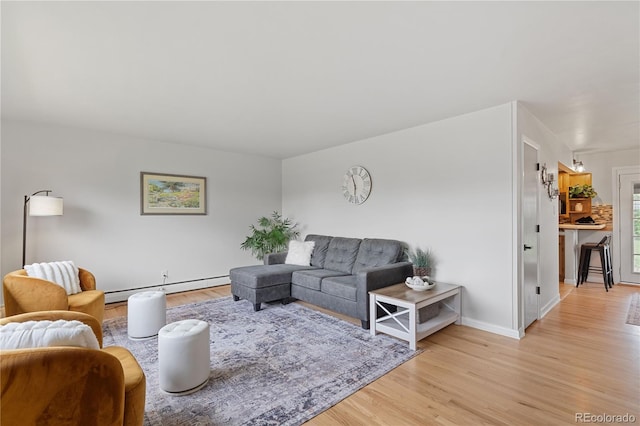 865 S Everett St, Lakewood, CO 80226 - living room featuring baseboards, baseboard heating, and light wood finished floors