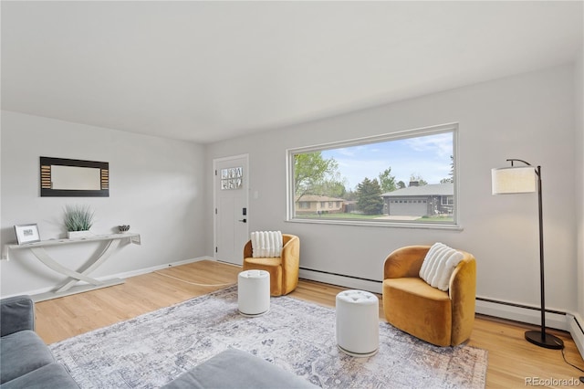 865 S Everett St, Lakewood, CO 80226 - living area featuring baseboards, wood finished floors, and a baseboard radiator