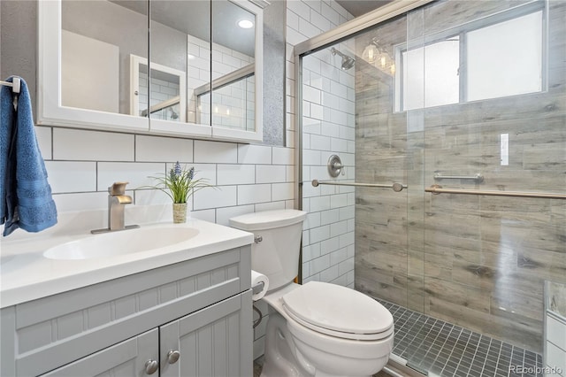 865 S Everett St, Lakewood, CO 80226 - full bath featuring vanity, a shower stall, toilet, and tile walls