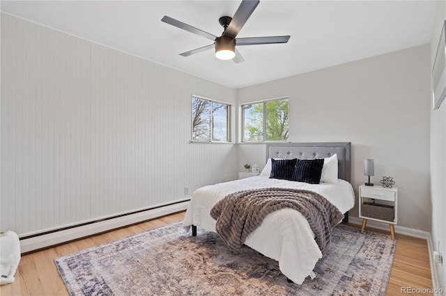 865 S Everett St, Lakewood, CO 80226 - bedroom with wood finished floors, baseboards, ceiling fan, and a baseboard heating unit