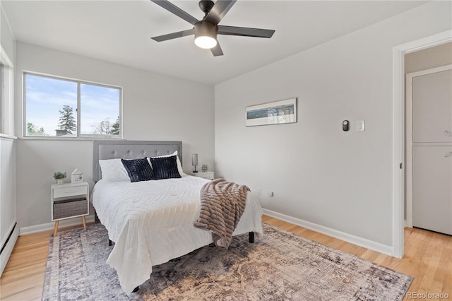 865 S Everett St, Lakewood, CO 80226 - bedroom with baseboards, a baseboard radiator, a ceiling fan, and light wood finished floors