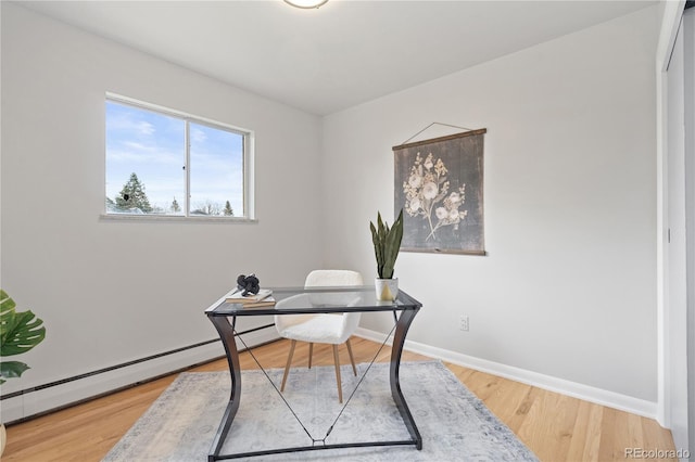 865 S Everett St, Lakewood, CO 80226 - office space with wood finished floors, baseboards, and a baseboard heating unit