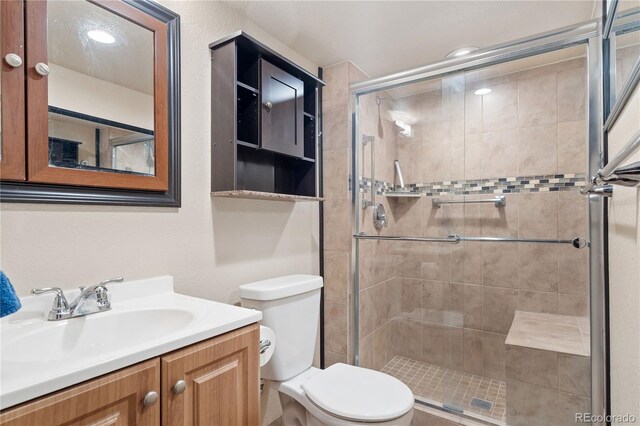 865 S Everett St, Lakewood, CO 80226 - bathroom with toilet, a shower stall, and vanity