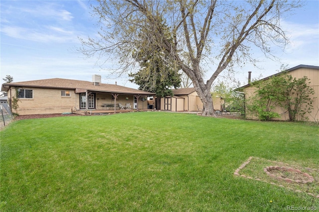865 S Everett St, Lakewood, CO 80226 - view of yard featuring a storage shed and an outbuilding