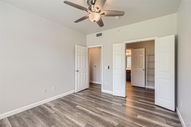 unfurnished bedroom with baseboards, wood finished floors, and ceiling fan