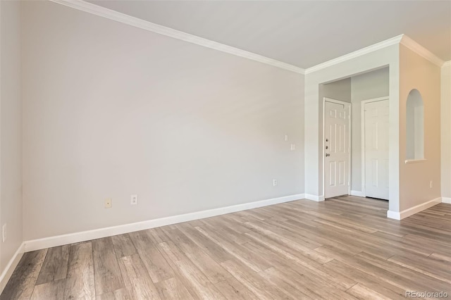 unfurnished room featuring ornamental molding, baseboards, and light wood finished floors