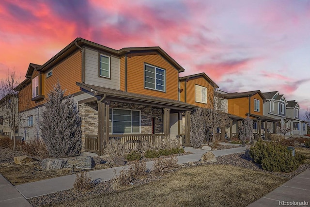 21613 E 59th Pl, Aurora, CO 80019 - view of front facade with covered porch, stone siding, and a residential view