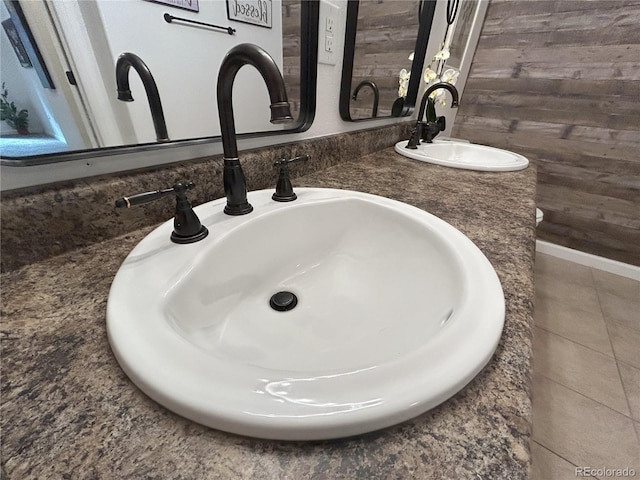 details with double vanity, wooden walls, and a sink