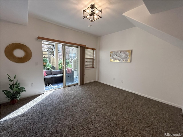 interior space with vaulted ceiling, baseboards, and dark colored carpet