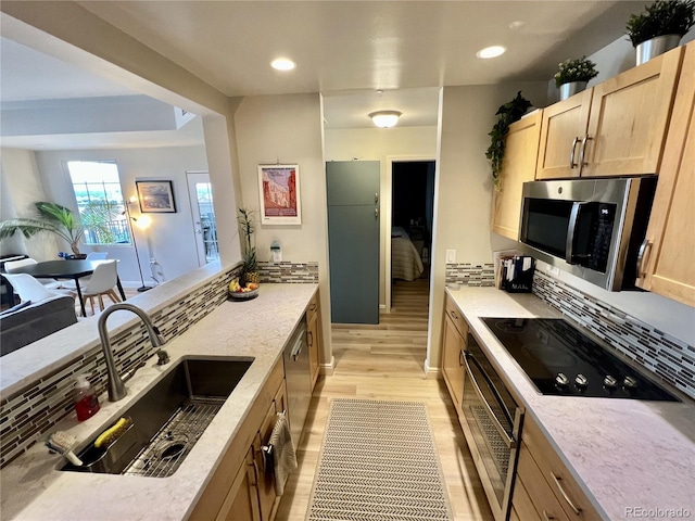 300 W 11th Ave Unit 10D, Denver, CO 80204 - kitchen featuring stainless steel microwave, a sink, light brown cabinetry, light wood finished floors, and wall oven