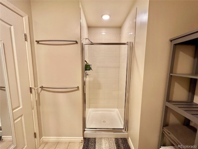 300 W 11th Ave Unit 10D, Denver, CO 80204 - full bathroom with a shower stall, baseboards, and tile patterned floors