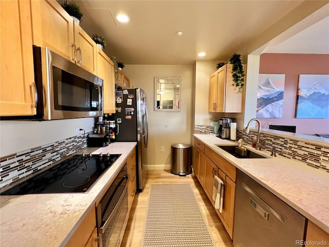300 W 11th Ave Unit 10D, Denver, CO 80204 - kitchen featuring appliances with stainless steel finishes, light brown cabinetry, tasteful backsplash, recessed lighting, and light wood-type flooring