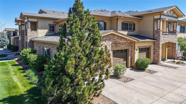 11374 Xavier Dr Unit 202, Westminster, CO 80031 - prairie-style home featuring stone siding, driveway, and an attached garage