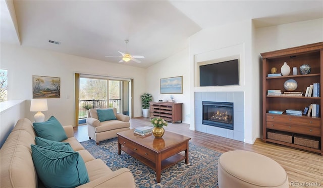 11374 Xavier Dr Unit 202, Westminster, CO 80031 - living room featuring lofted ceiling, a fireplace, wood finished floors, and a ceiling fan