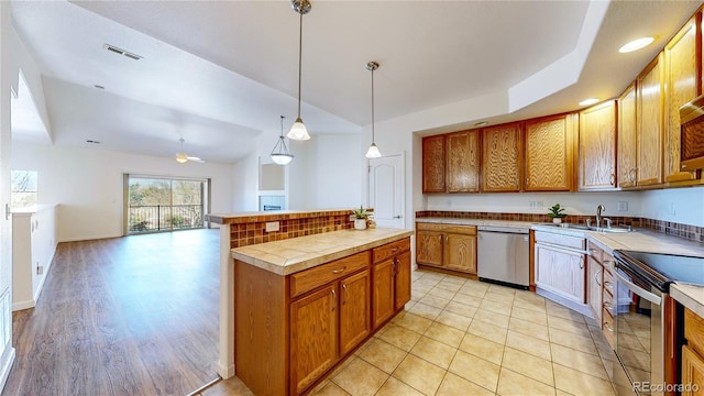 11374 Xavier Dr Unit 202, Westminster, CO 80031 - kitchen featuring stainless steel appliances, a sink, ceiling fan, brown cabinets, and pendant lighting