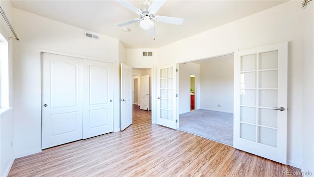 11374 Xavier Dr Unit 202, Westminster, CO 80031 - unfurnished bedroom featuring light wood-style flooring, a closet, french doors, baseboards, and a ceiling fan