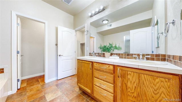 11374 Xavier Dr Unit 202, Westminster, CO 80031 - full bathroom featuring double vanity, baseboards, and stone finish floors