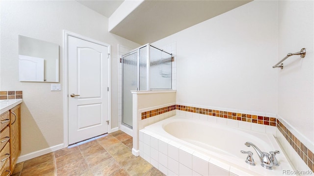 11374 Xavier Dr Unit 202, Westminster, CO 80031 - full bathroom with vanity, a shower stall, a garden tub, and baseboards