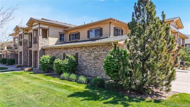 11374 Xavier Dr Unit 202, Westminster, CO 80031 - view of home's exterior featuring a lawn and stone siding