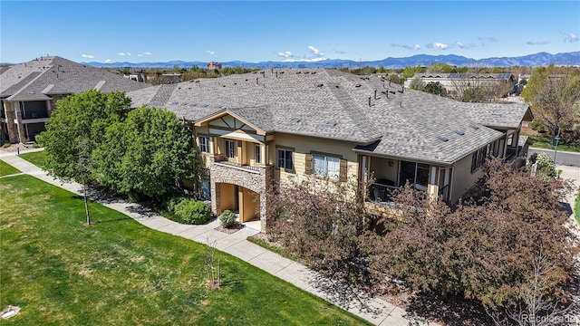 11374 Xavier Dr Unit 202, Westminster, CO 80031 - single story home featuring stone siding, a balcony, stucco siding, and a front yard