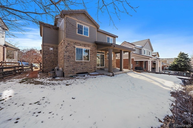 snow covered house with covered porch