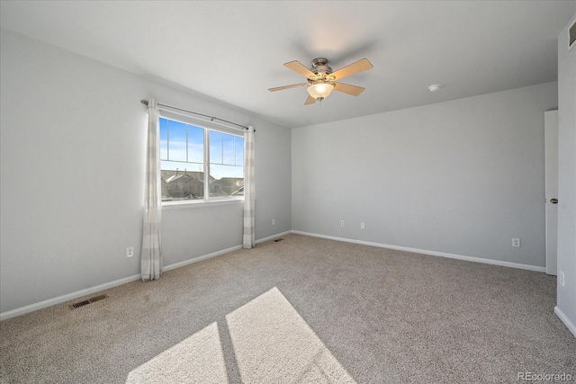 carpeted empty room featuring ceiling fan