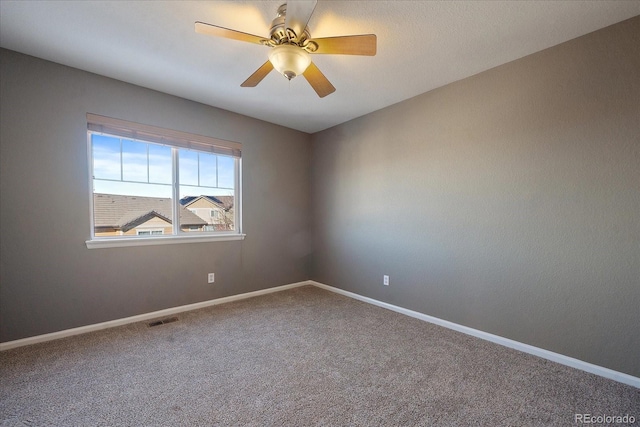 spare room featuring ceiling fan and carpet flooring