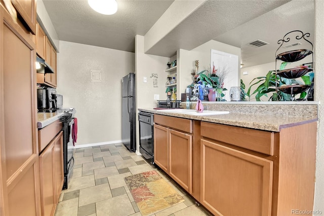 kitchen featuring sink, light stone countertops, a textured ceiling, and black appliances