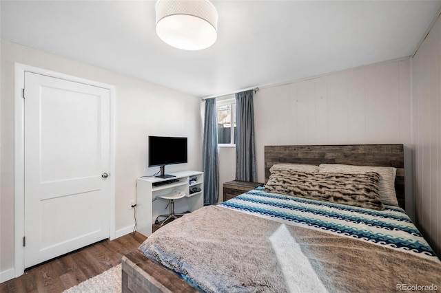 bedroom featuring dark hardwood / wood-style flooring