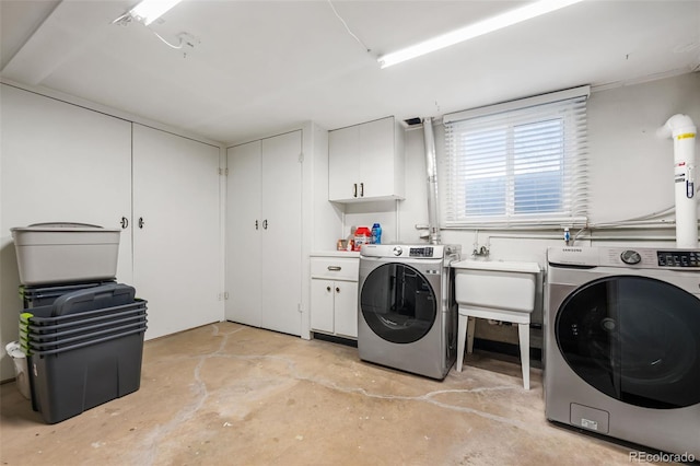 laundry room featuring sink, cabinets, and washing machine and clothes dryer