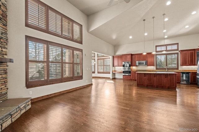 kitchen with a towering ceiling, wine cooler, and light countertops