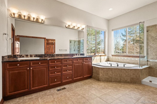 bathroom featuring a sink, visible vents, a bath, double vanity, and a stall shower