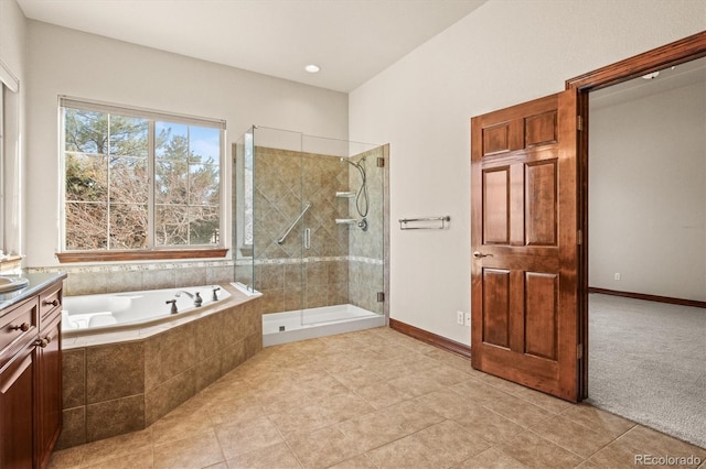 full bathroom featuring a garden tub, vanity, baseboards, a shower stall, and tile patterned floors