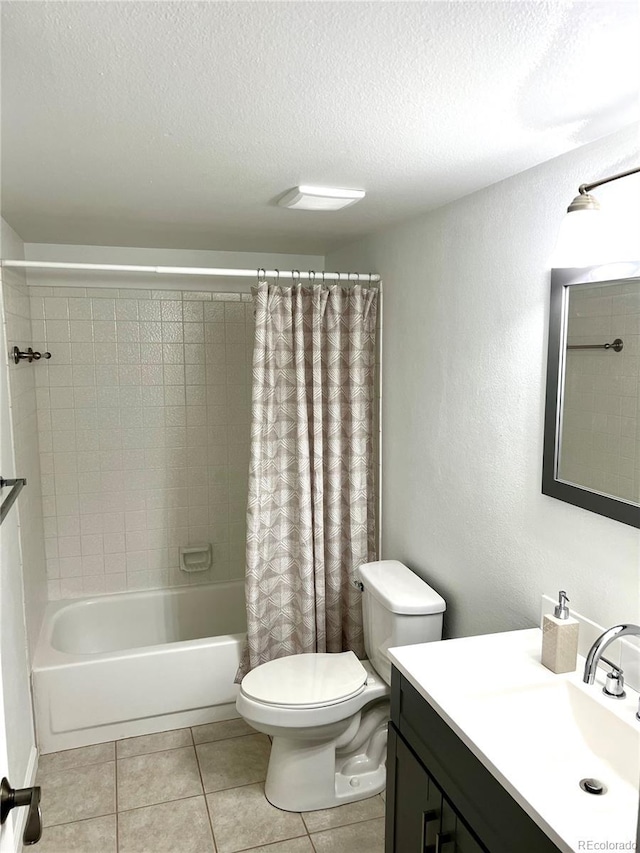 full bathroom featuring toilet, a textured ceiling, shower / bath combo, vanity, and tile patterned floors