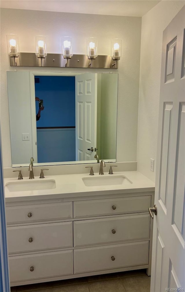bathroom with double vanity and tile patterned floors