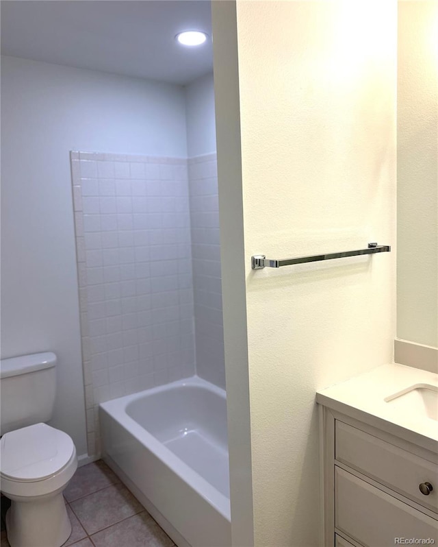 bathroom with toilet, tile patterned floors, and vanity