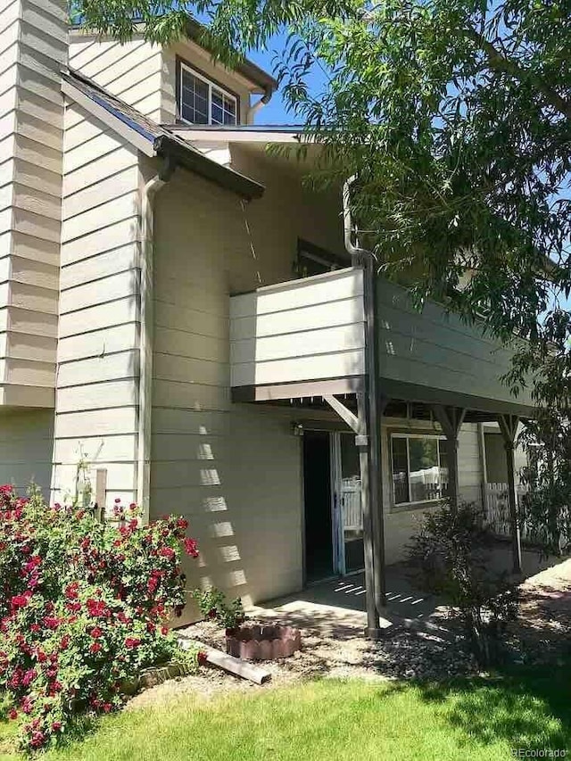 view of home's exterior with a balcony and a patio