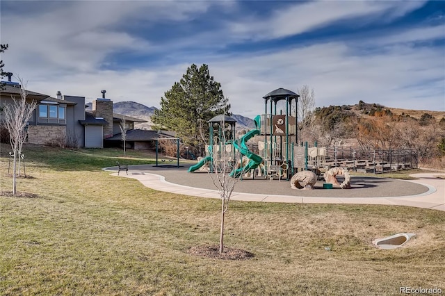 community play area featuring a lawn and a mountain view