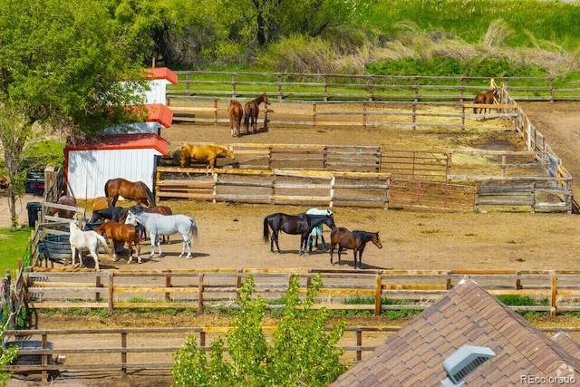 surrounding community featuring an exterior structure and a view of rural / pastoral area