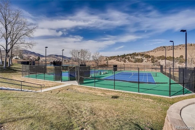 view of tennis court with a mountain view