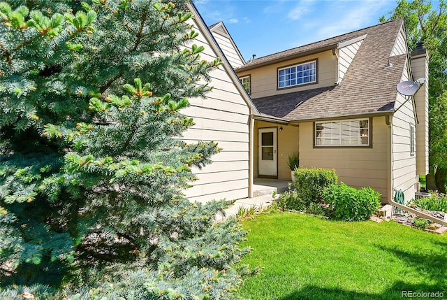 10369 E Red Mtn, Littleton, CO 80127 - view of front of house featuring a chimney, a front lawn, and a shingled roof