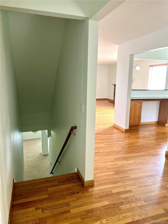 10369 E Red Mtn, Littleton, CO 80127 - stairs featuring baseboards and wood finished floors