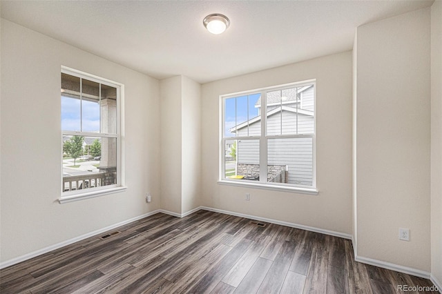 26267 E 3rd Ave, Aurora, CO 80018 - unfurnished room featuring dark wood-type flooring and baseboards